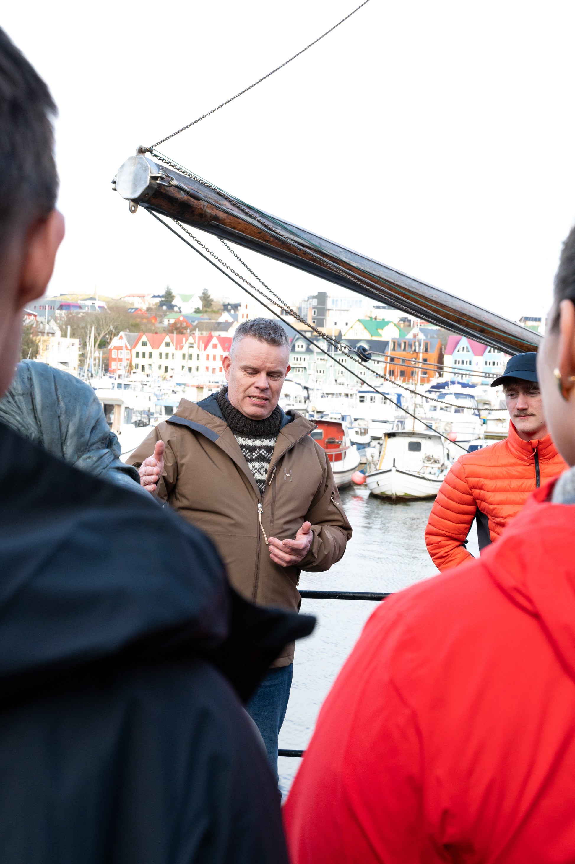 Local guide leading a walking tour in Tórshavn harbor, Faroe Islands